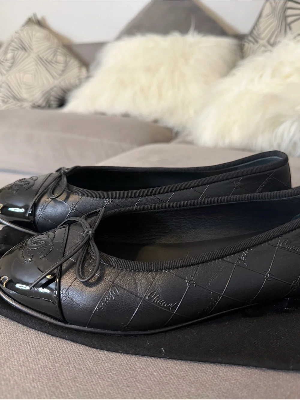 CHANEL Black Quilted Leather Cap-Toe Bow Ballet Flats